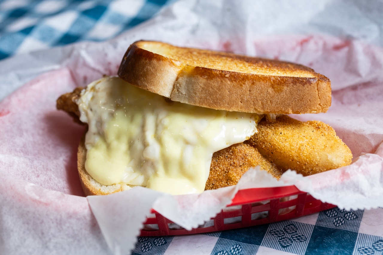 Simply heavenly fish sandwich topped with fried egg, cheese: Best Eats [Video]